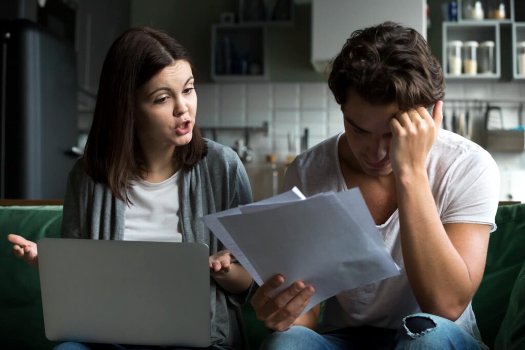 Couple reviewing medical bills and documents after an accident, illustrating economic and non-economic damages in a California personal injury case