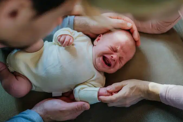 Medical team monitoring mother and baby during labor to prevent delivery room trauma